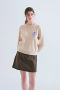 Jersey punto beige con detalle de uva