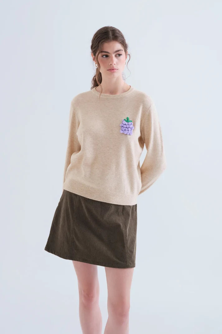 Jersey punto beige con detalle de uva