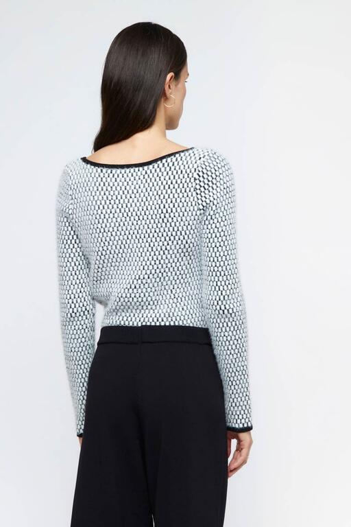 Vista trasera del jersey de textura blanco y negro Wild Pony, con detalles de diseño geométrico y acabado en cuello redondo.