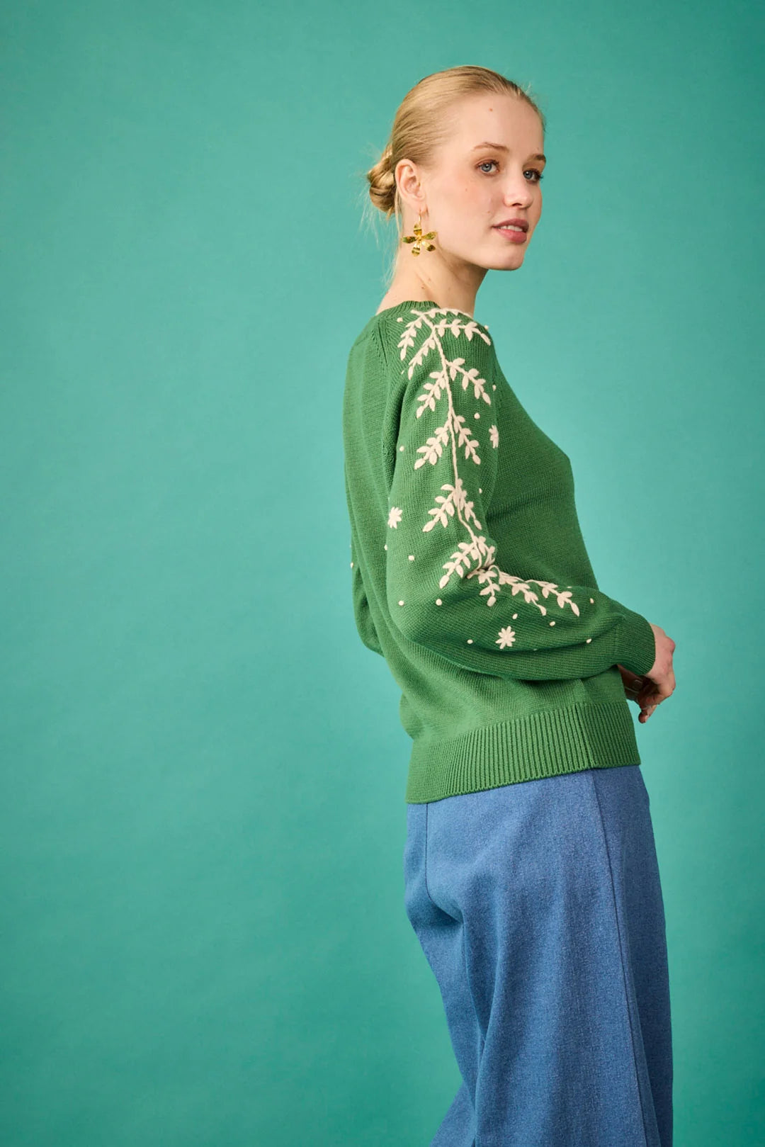Jersey verde con bordado floral en las mangas