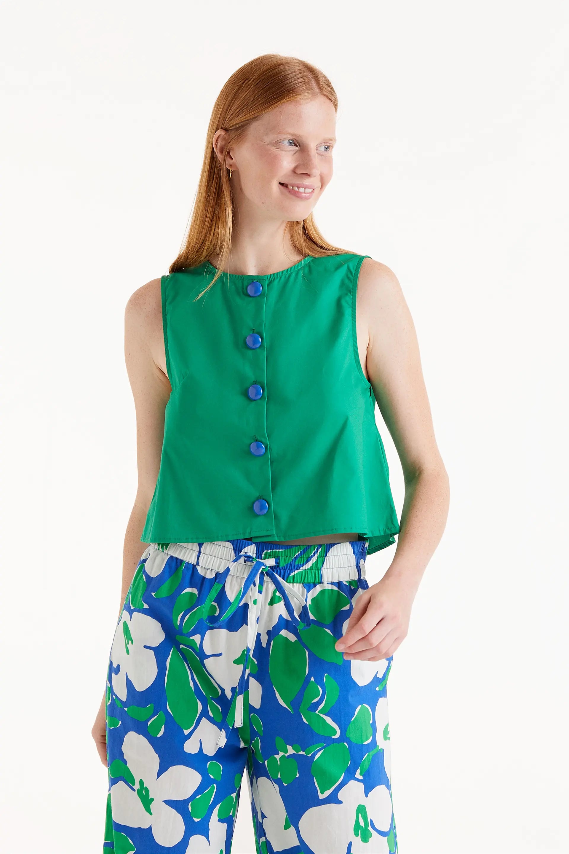 Top Sin Mangas Con Botones Verde. Top verde sin mangas con botones azules al frente.